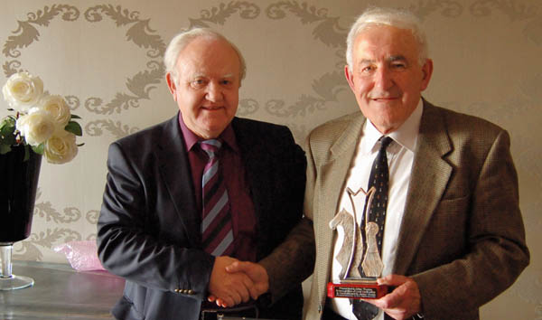 Brian Thorpe (r) receiving a presentation, from Michael Crowe, during the 2009 Irish Junior Chess Championships in Kilkenny, for his many years of service to junior chess.